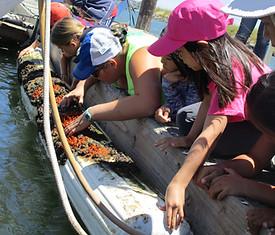 A group of people in a boat

Description automatically generated