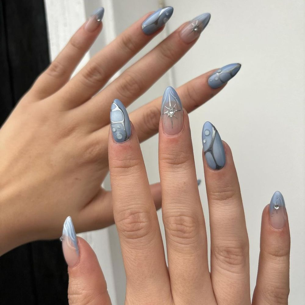 Close up of hands with blue winter nails having Silver Winter Nails