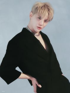 This contain Junsu tvxq  with blonde hair wearing a black dress