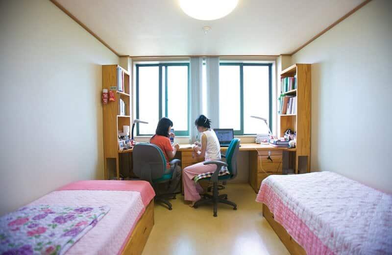 A couple of women sitting at a desk in a room

AI-generated content may be incorrect.