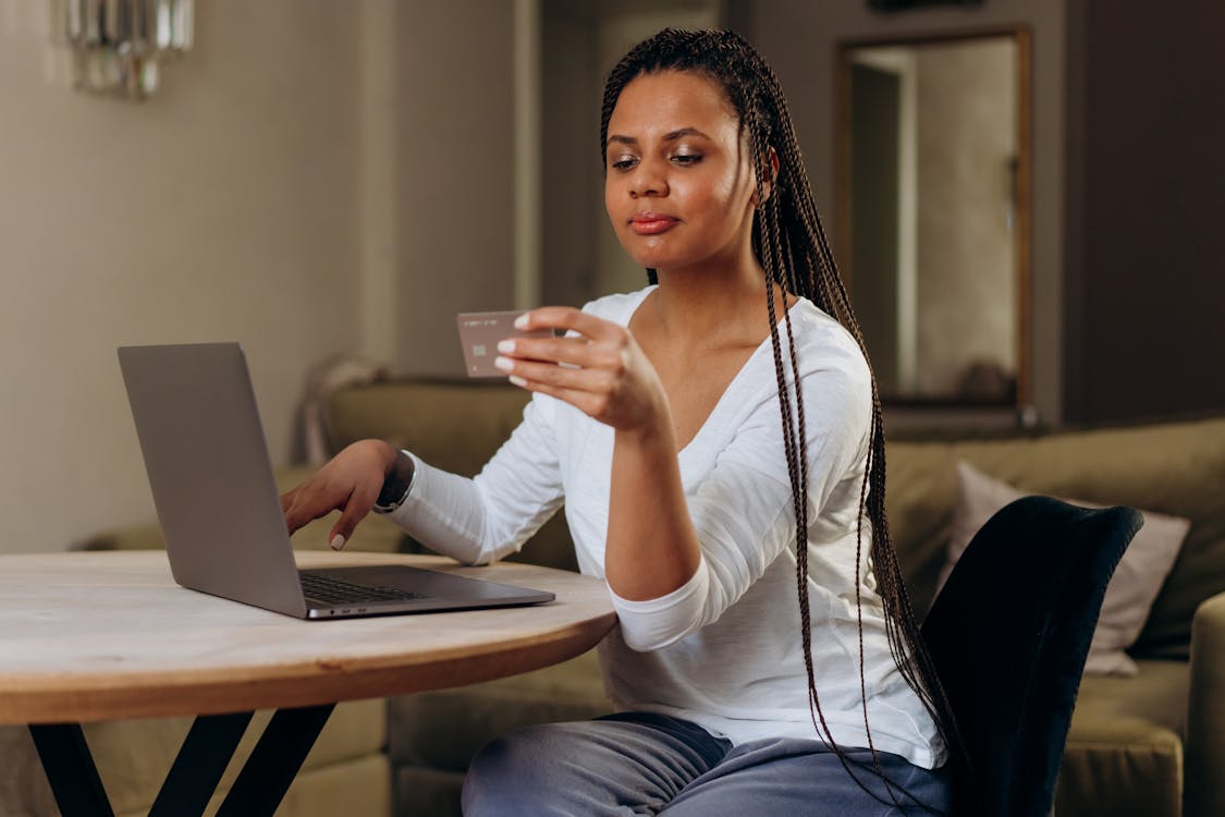 Free A Woman Using Her Credit Card Online Stock Photo