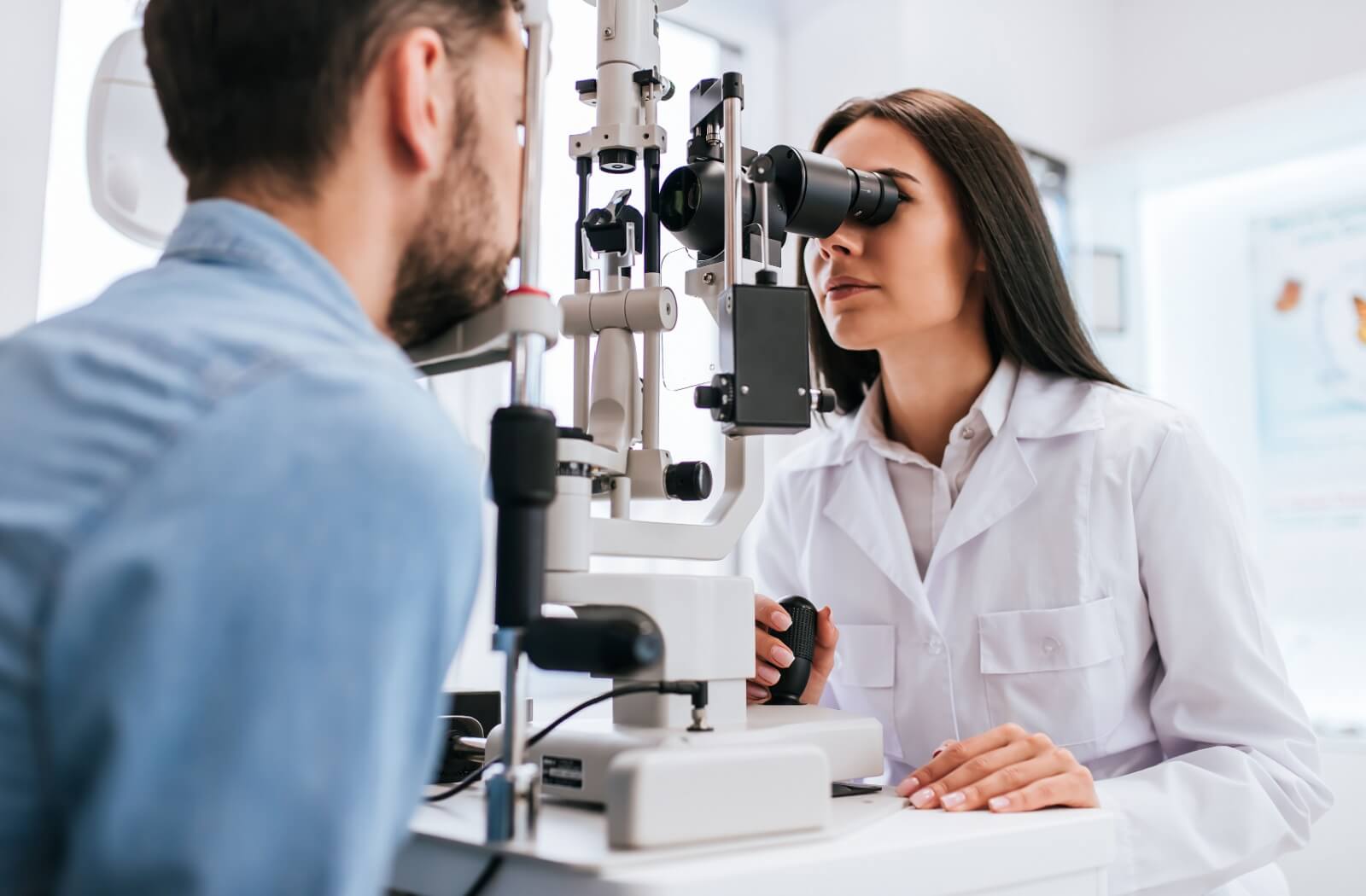 An optometrist uses specialty technology to examine the inside of a patient’s eyes during a comprehensive eye exam.