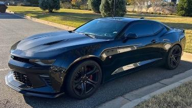 A black sports car parked on a street

AI-generated content may be incorrect.
