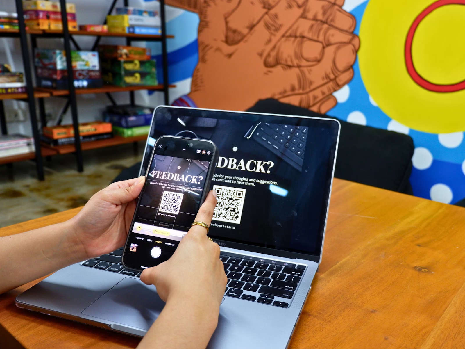 A person focused on their laptop, which displays a QR code on the screen, ready for scanning or sharing.