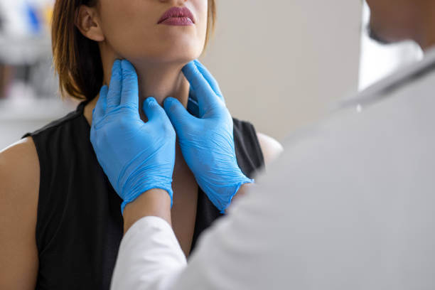 A doctor carefully examines a patient’s neck for thyroid health, illustrating the importance of regular thyroid check-ups.