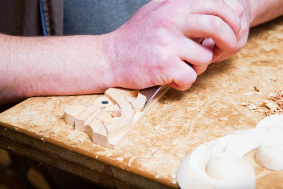 stock-photo-woodcarver-creates-a-furniture-ornament-woodcarvers-hands-chisels-tools-wood-carved-ornament