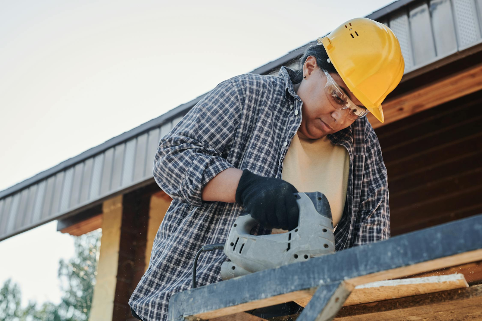 Woman in Yellow Hard Hat and Black and White Plaid Dress Shirt