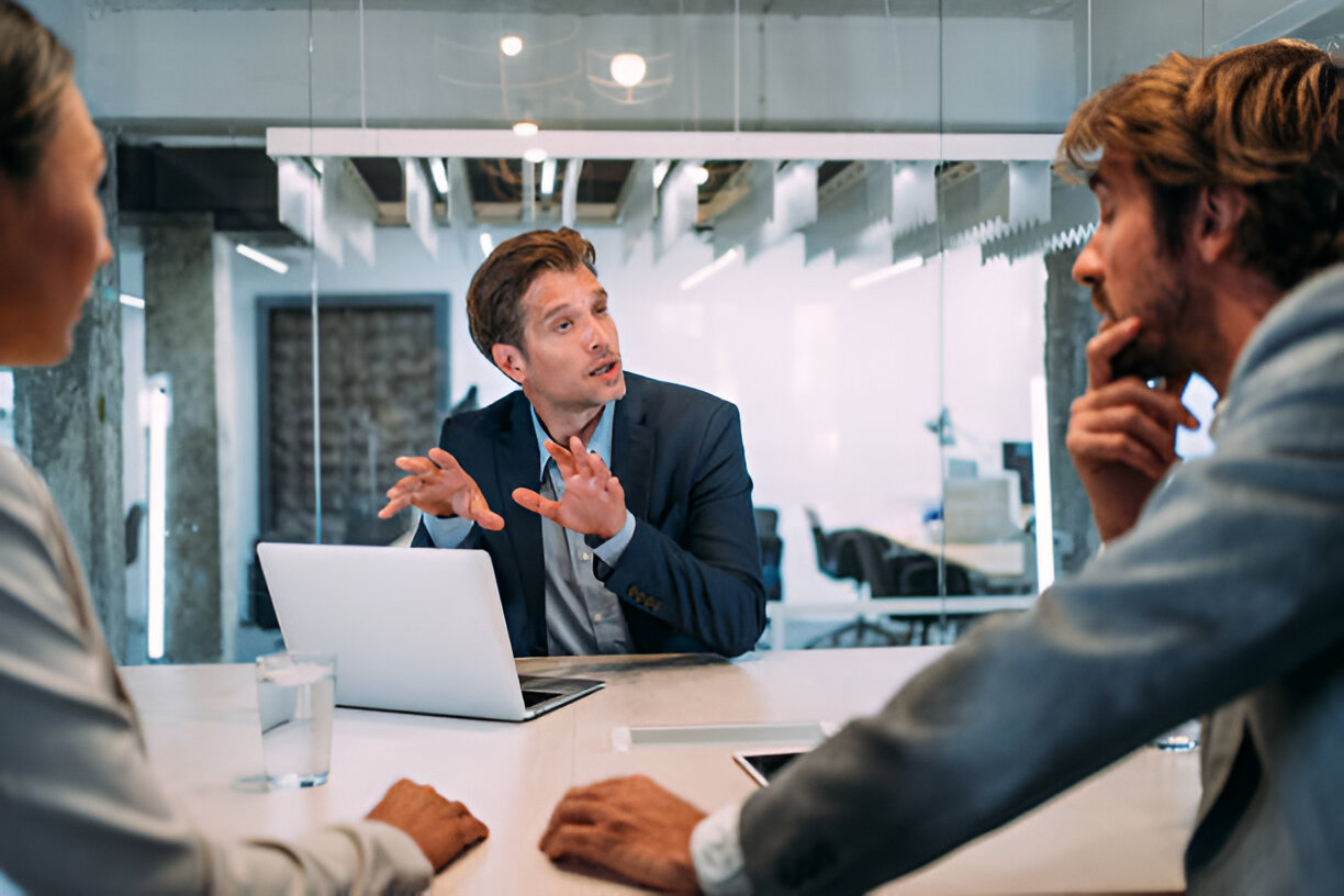 Business professional presenting financial strategies to colleagues during a meeting, emphasizing the importance of making informed financial decisions.