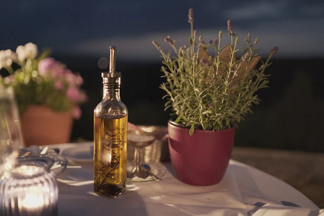 clear bottle of olive oil on kitchen bench