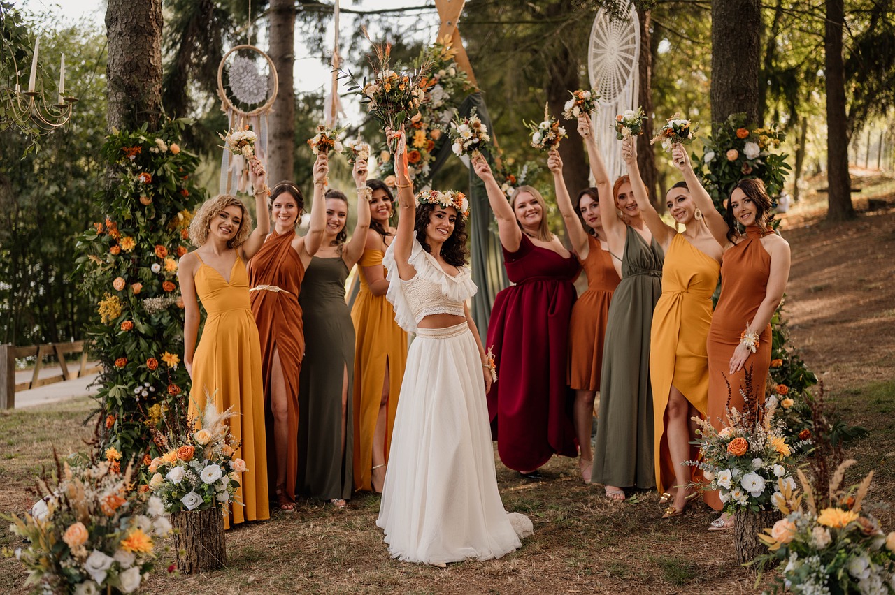 A bride with her bridesmaids/ Greenery in the background. 