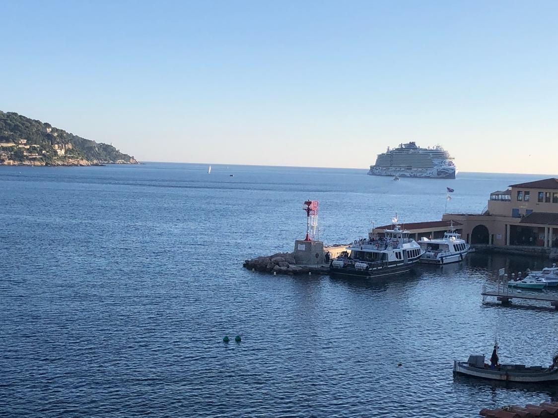 A body of water with boats and a building in the background

Description automatically generated