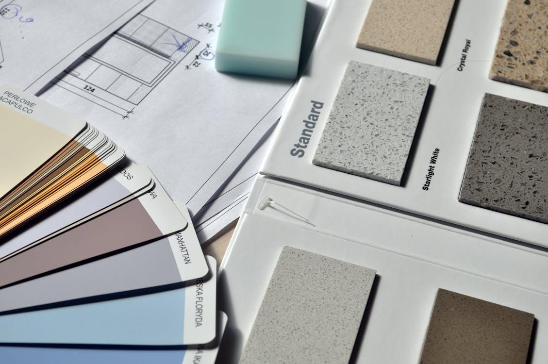 Free Color palette and material samples for interior renovation projects on a blueprint. Stock Photo