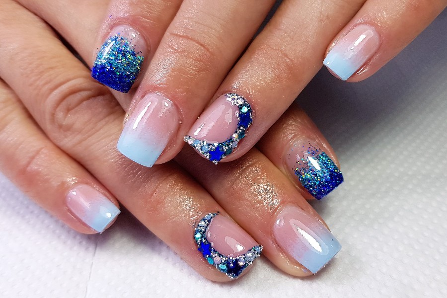 Constellation patterns add celestial beauty to a dreamy French nail tip design.