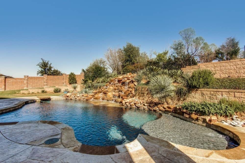 A stunning waterfall feature highlights the swimming pool.