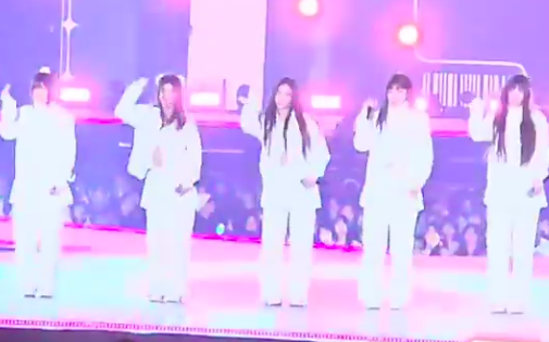 This contains an image of NewJeans performance at the Music Bank Festival in Japan