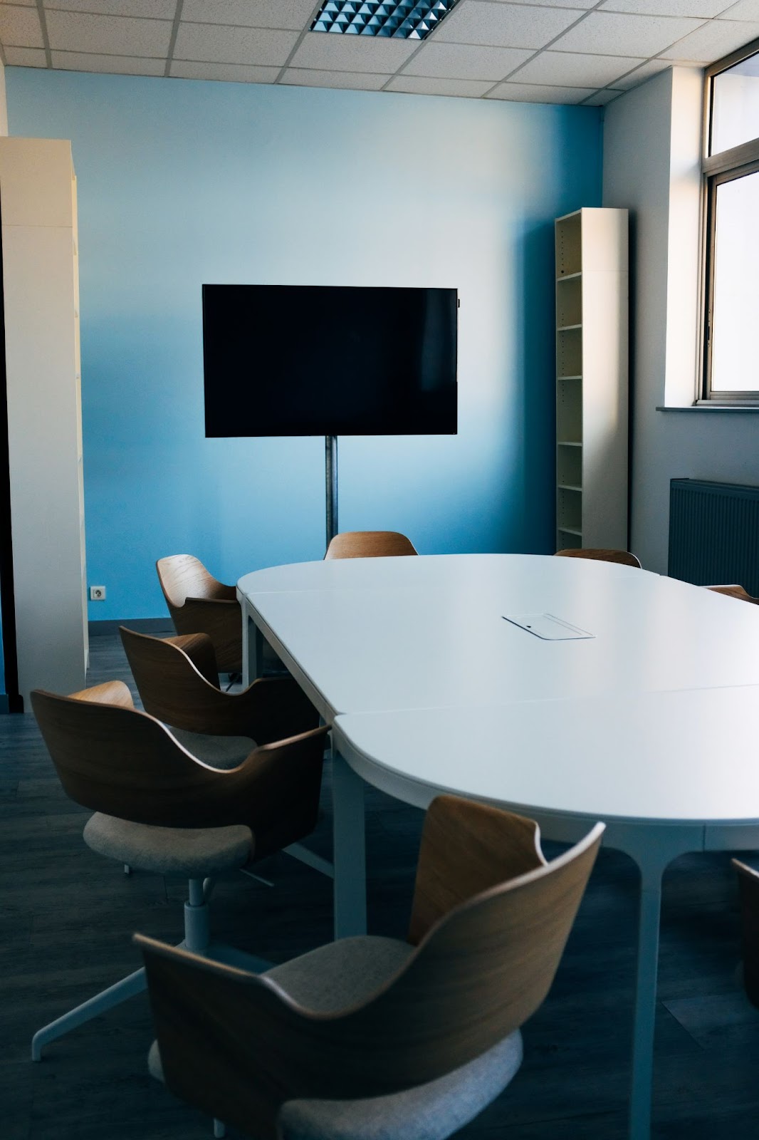 A freestanding TV of around 55 inches in a meeting room