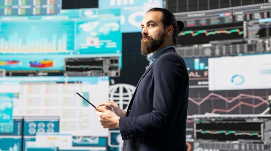 A person in a suit holding a tablet

AI-generated content may be incorrect.