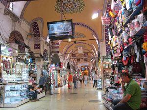 A large indoor market with many people with Grand Bazaar, Istanbul in the background

Description automatically generated with medium confidence