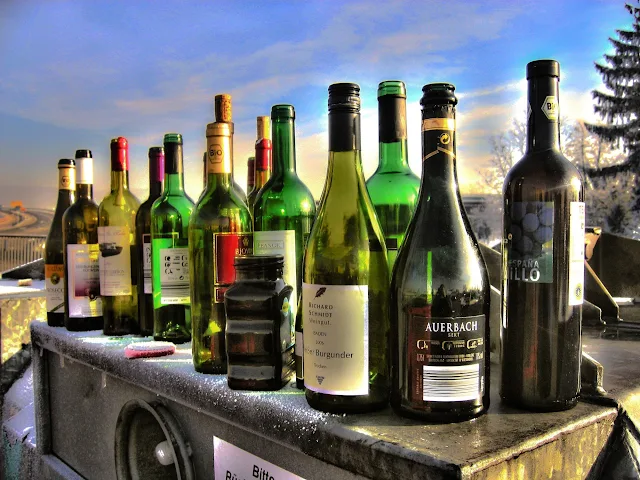 lots of different bottles of wine on counter