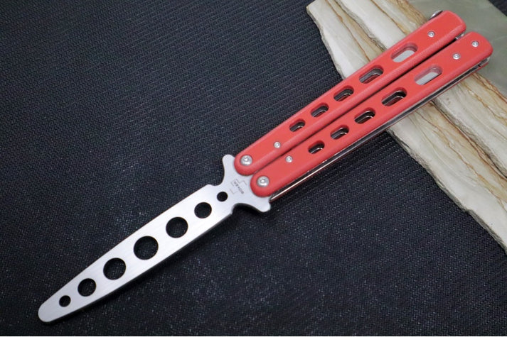 An image showcasing the Boker balisong trainer with red G-10 handles.