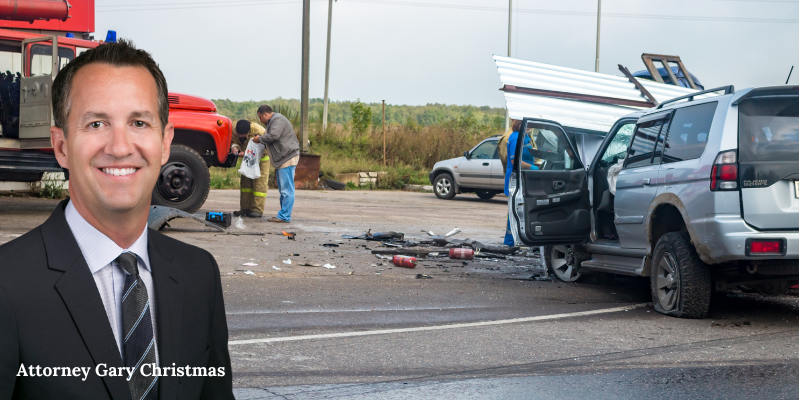 Attorney Gary Christmas in front of motor vehicle accident scene