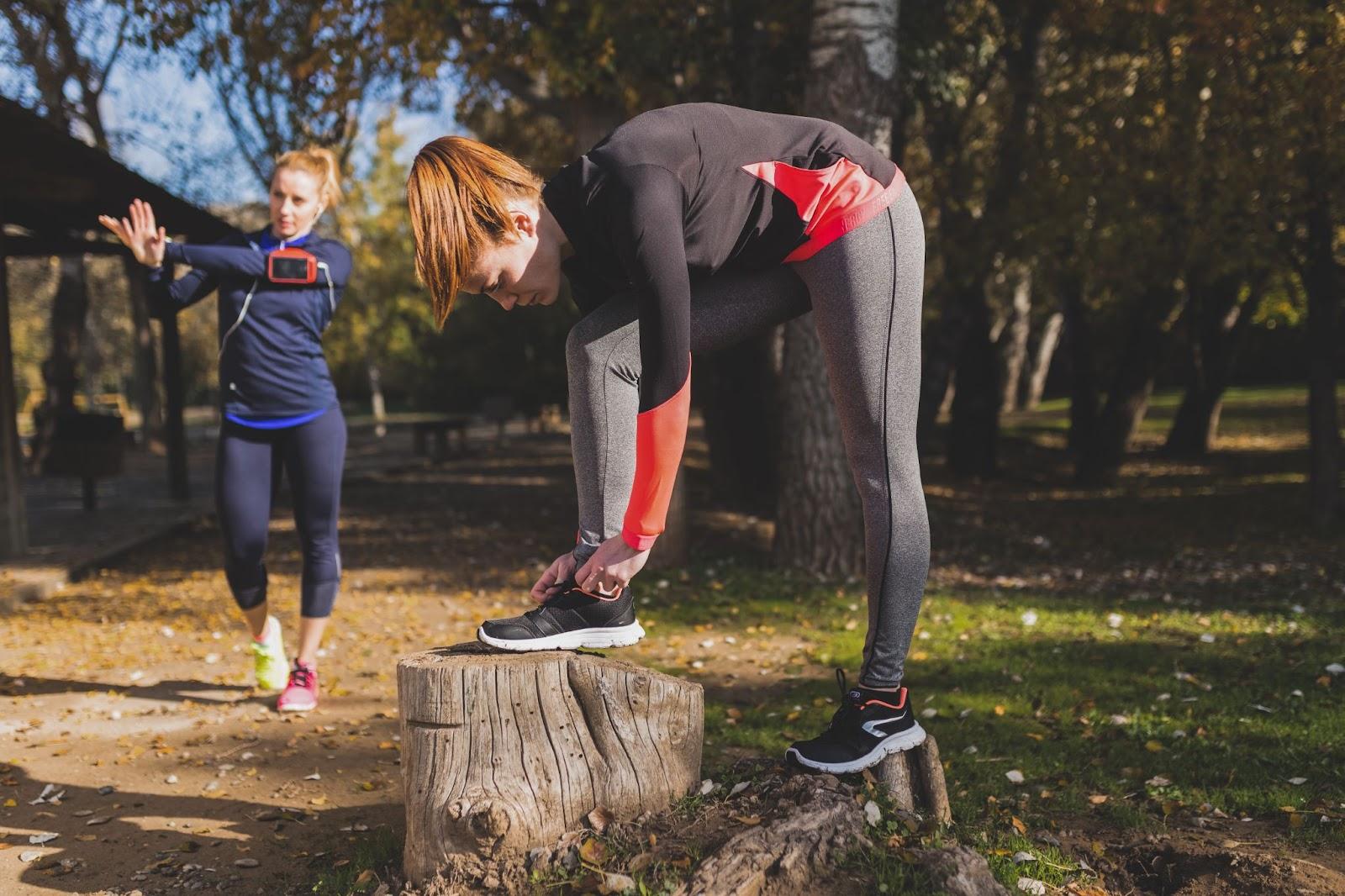 Two women are preparing for an outdoor workout session in a park in Toronto.