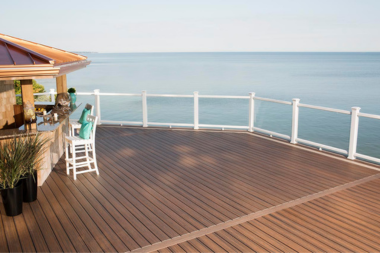 reasons to build a composite deck for your lake home trex decking with railing and bar area custom built michigan