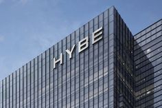 This may contain the hybe logo is on top of a building