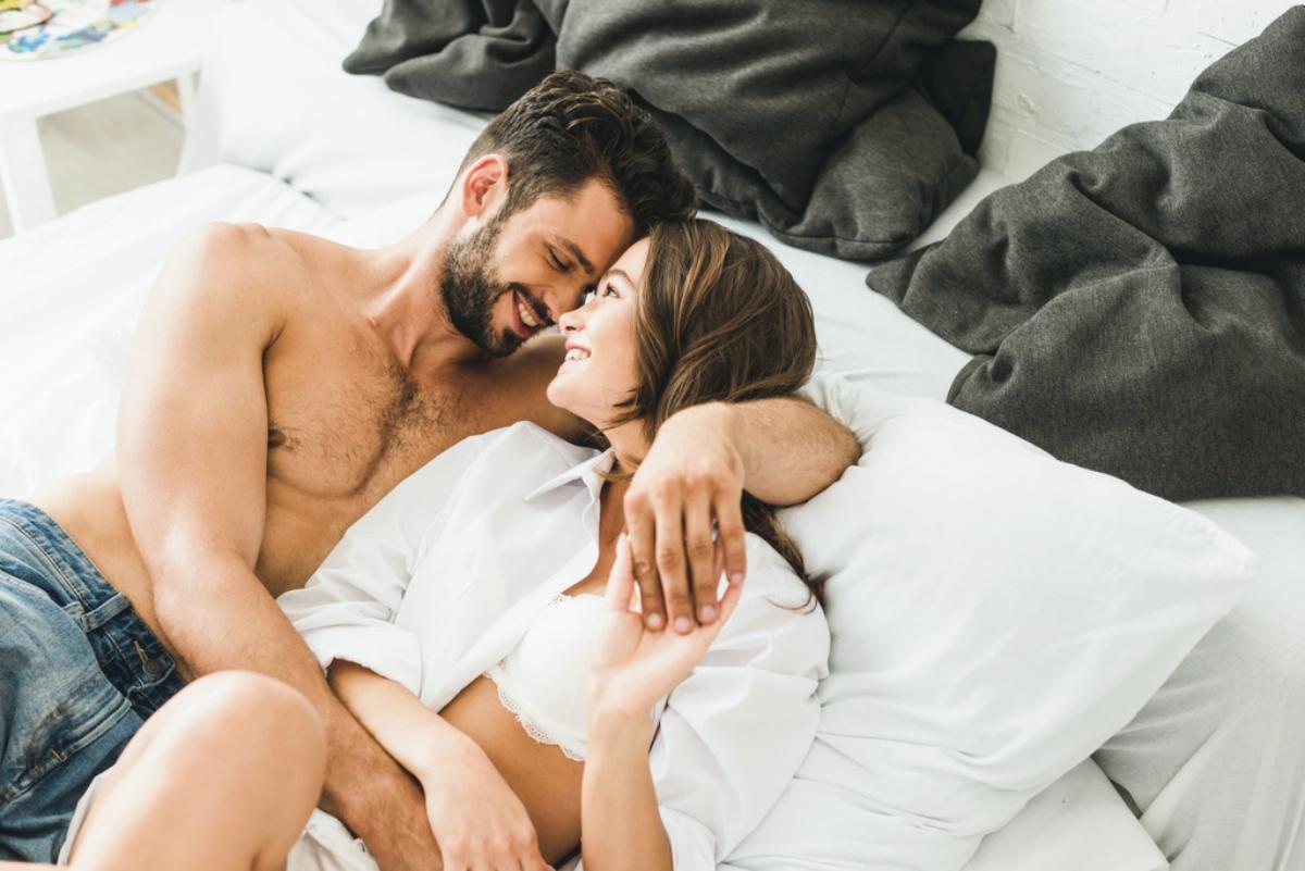 Sexy couple hugging in bed