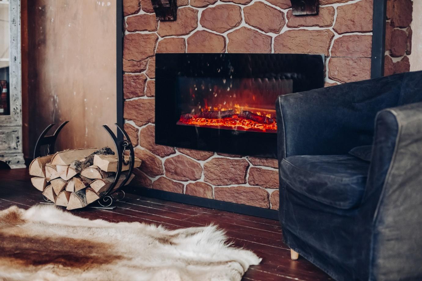 A fireplace with a fur rug and a couch

Description automatically generated