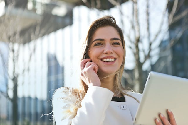 A person on the phone smiling.