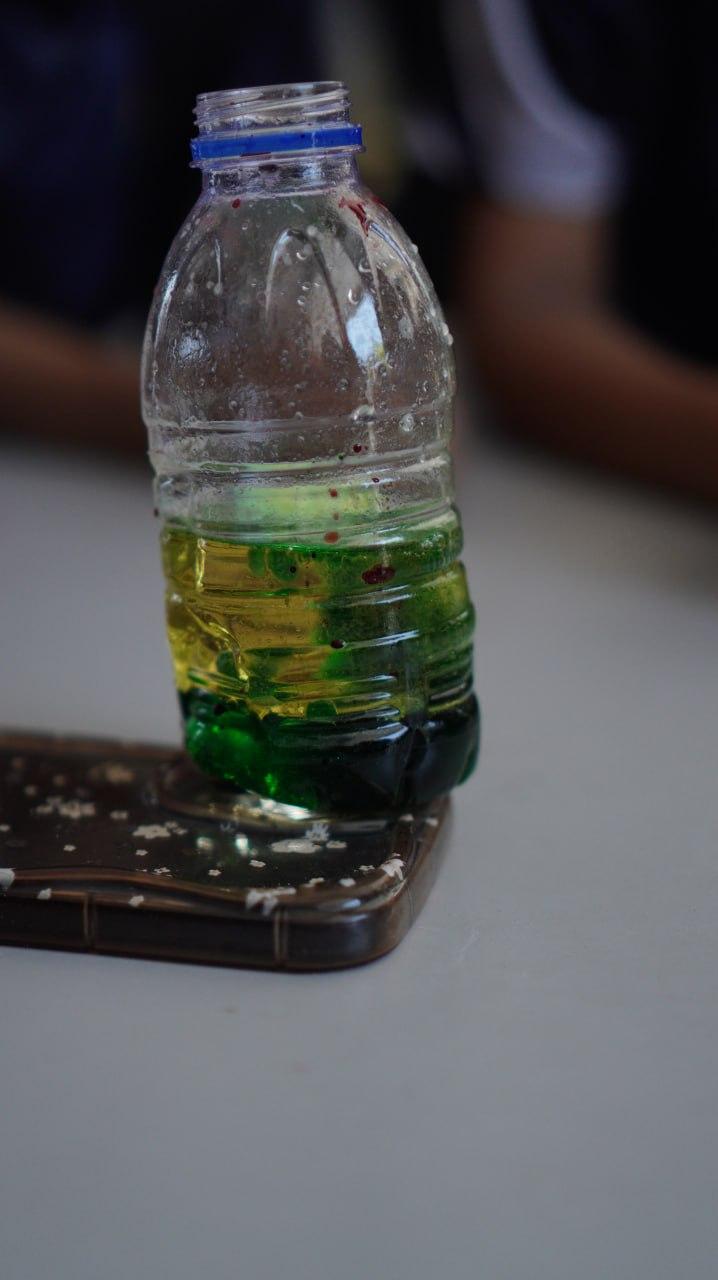 A plastic bottle with green liquid on a phone case

Description automatically generated