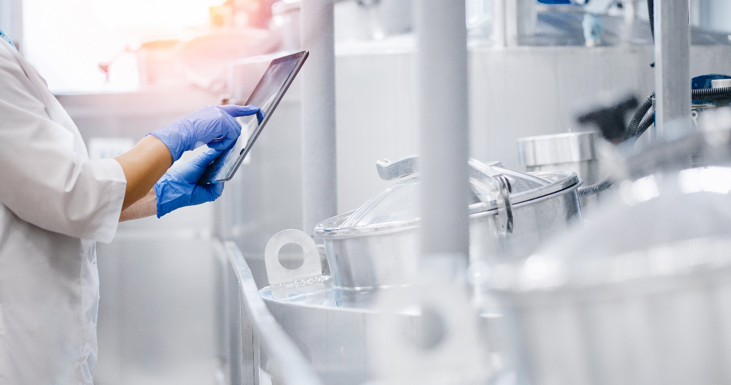 Person holding tablet in dairy factory