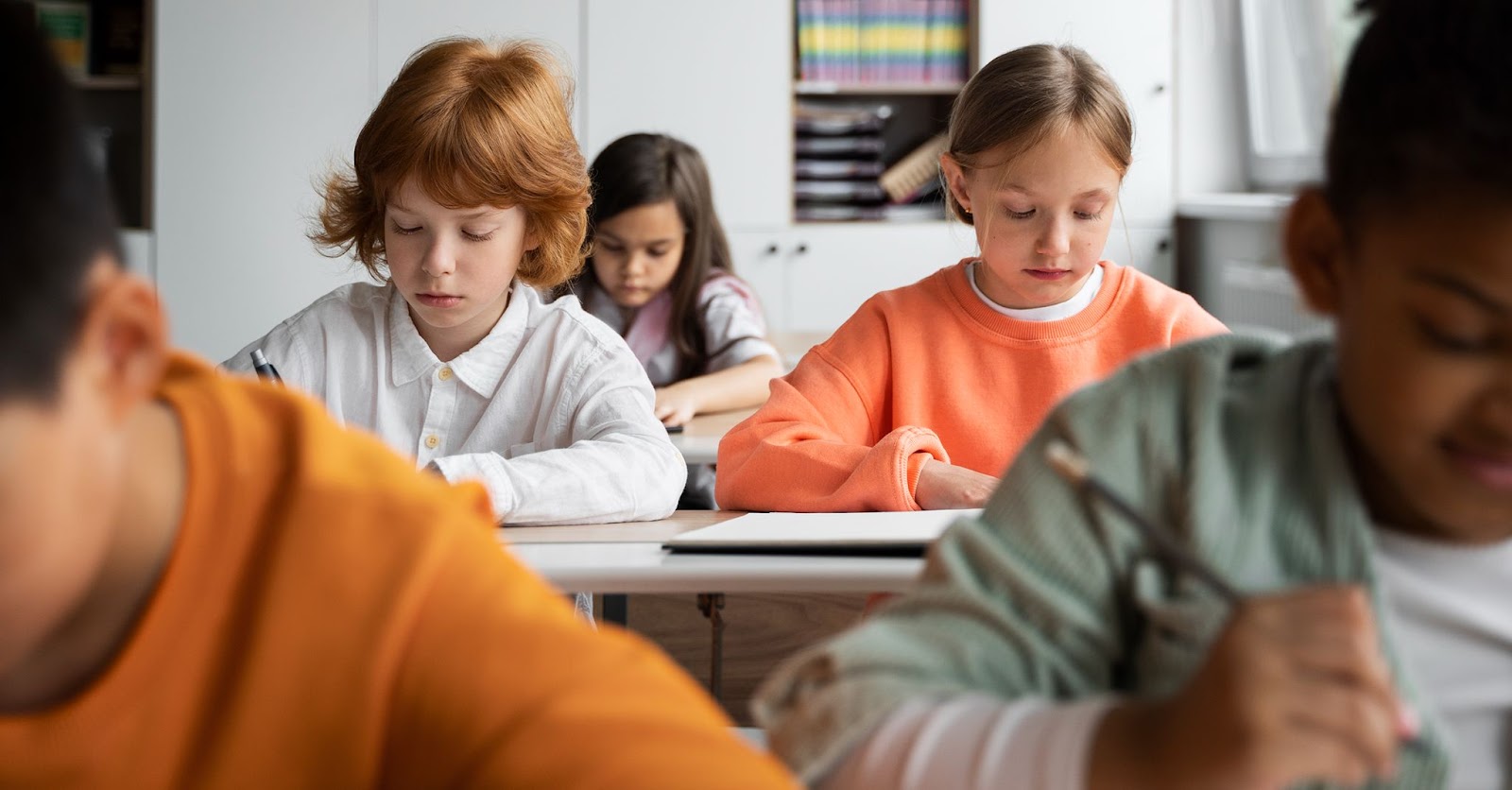 Children concentrating in their classroom in one of the states providing above average education.