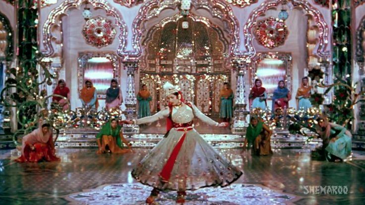 This may contain: a woman in a white and red dress is dancing on stage with other people around her