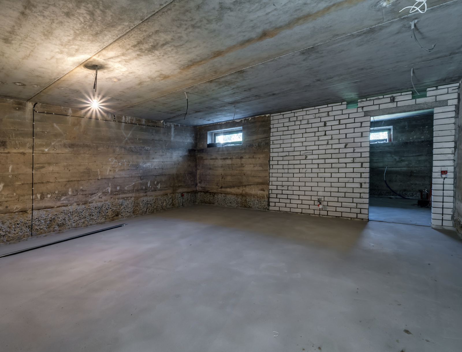 An image of an unfinished basement introducing the title of the article “Basement Waterproofing Methods: Effective Solutions”.