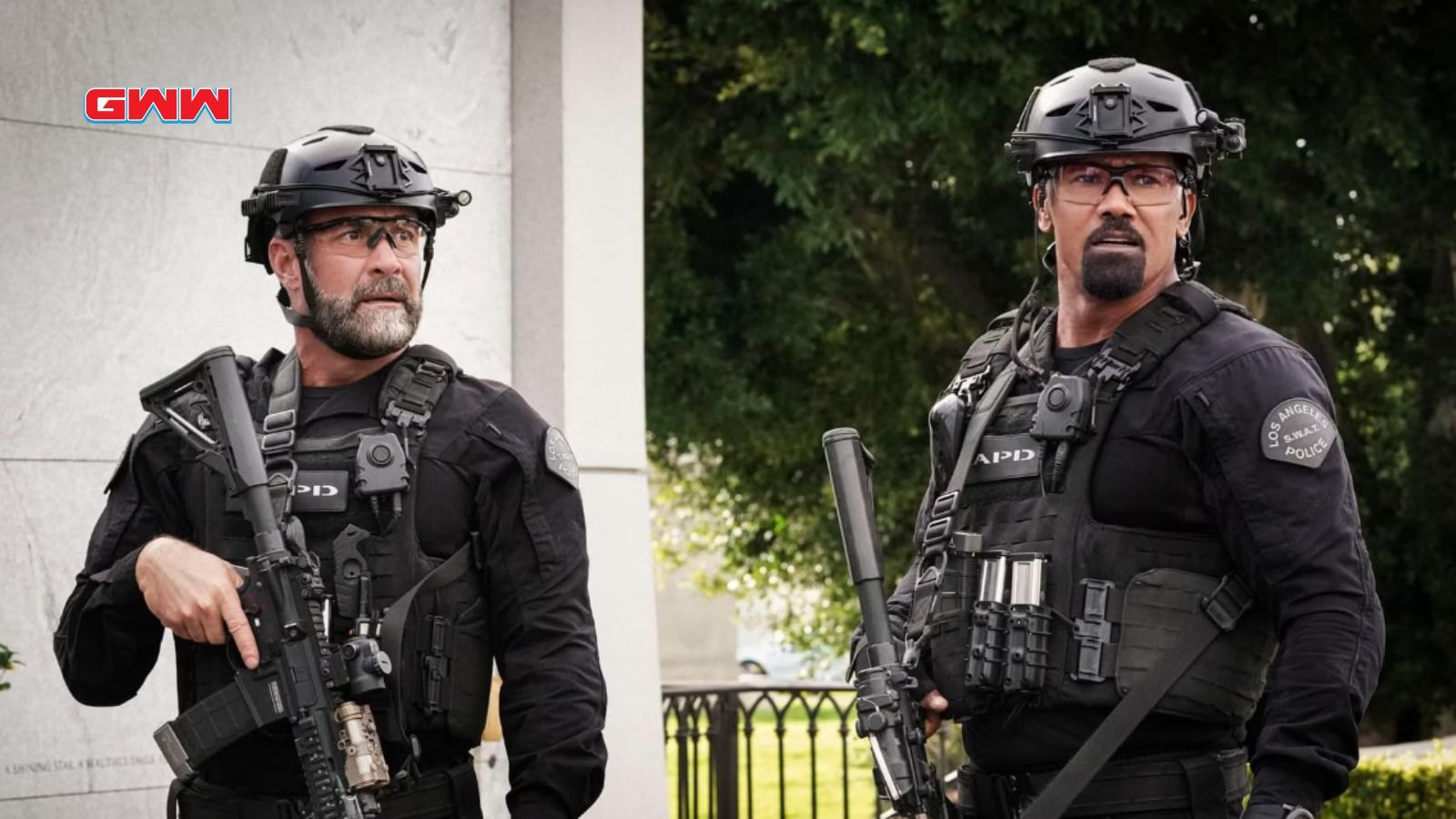 Sergeant Hondo and Deacon in tactical gear, standing with rifles ready.