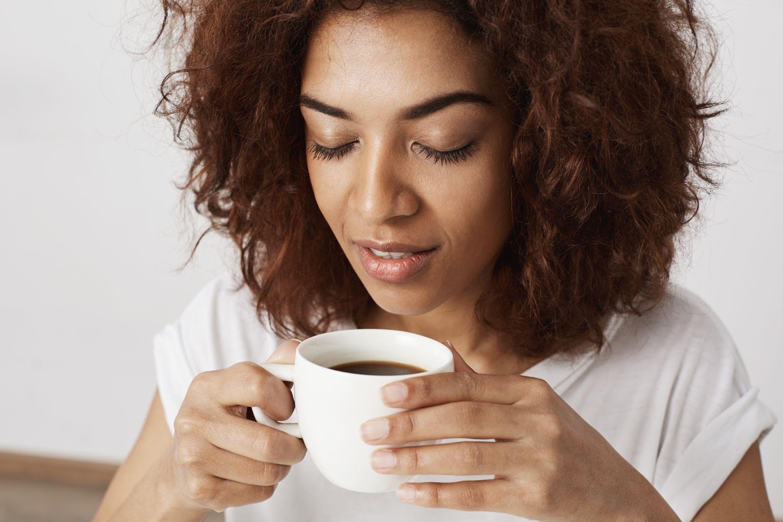 A woman drinking mushroom coffee