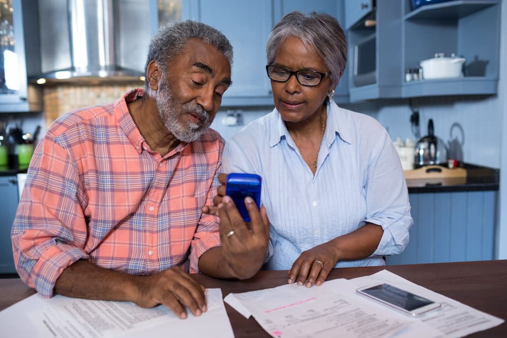 Elderly couple reviewing retirement planning documents