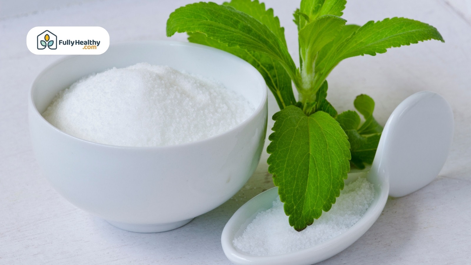 Stevia powder in bowl with fresh stevia leaves on side