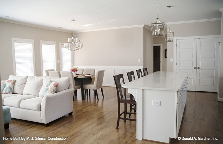 An open layout view showing the living area, dining space, and kitchen.