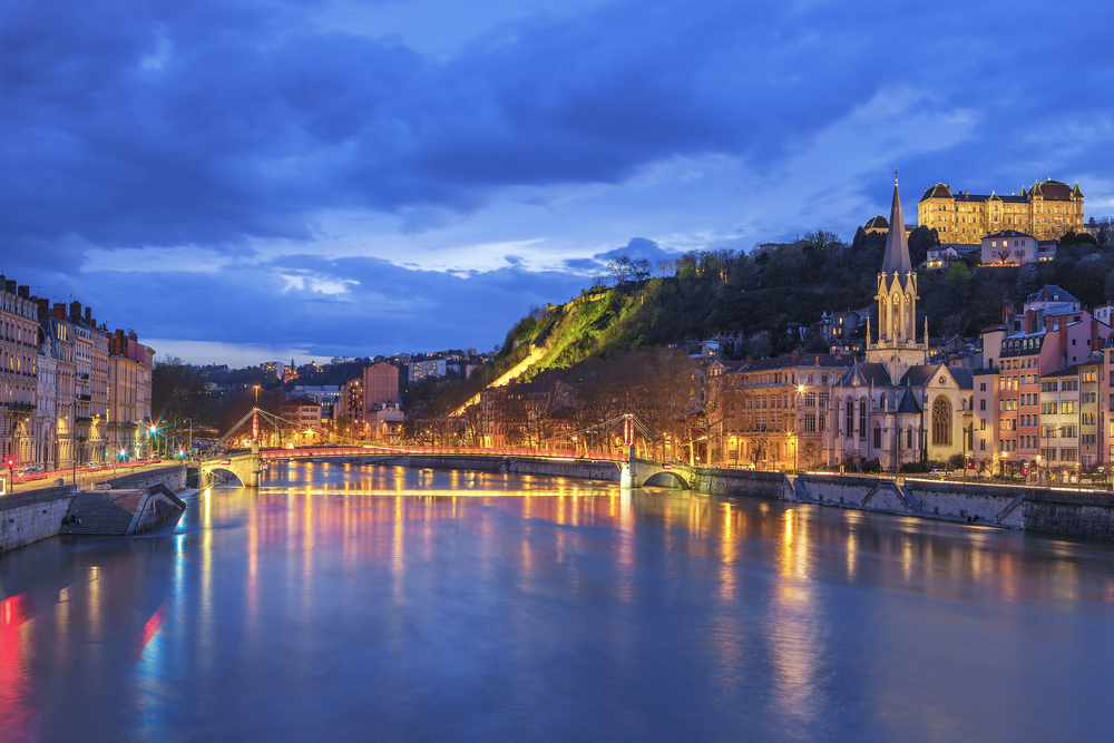 Lyon at night with lights reflecting on the river