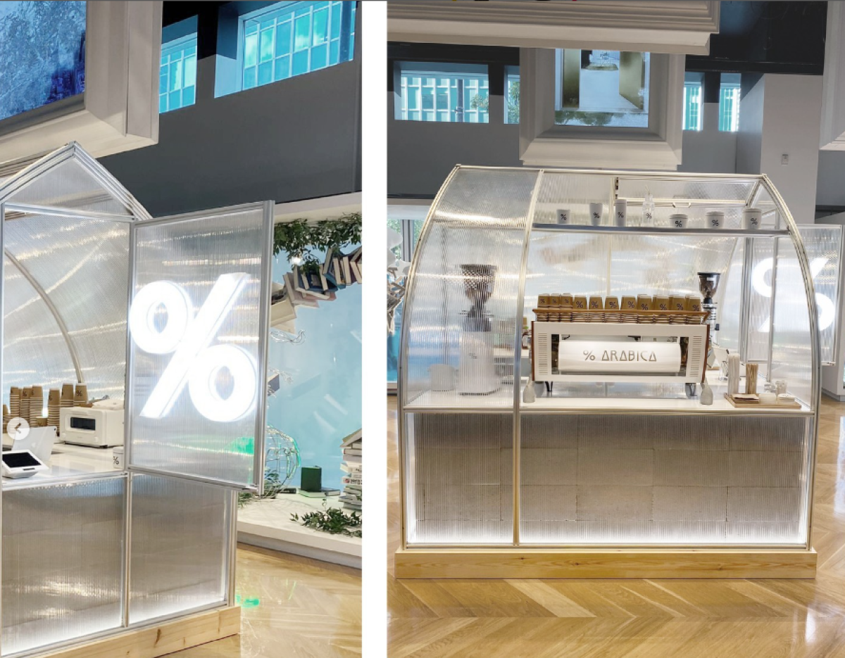 Two side by side photos of a minimalist coffee stand with a neon white % sign