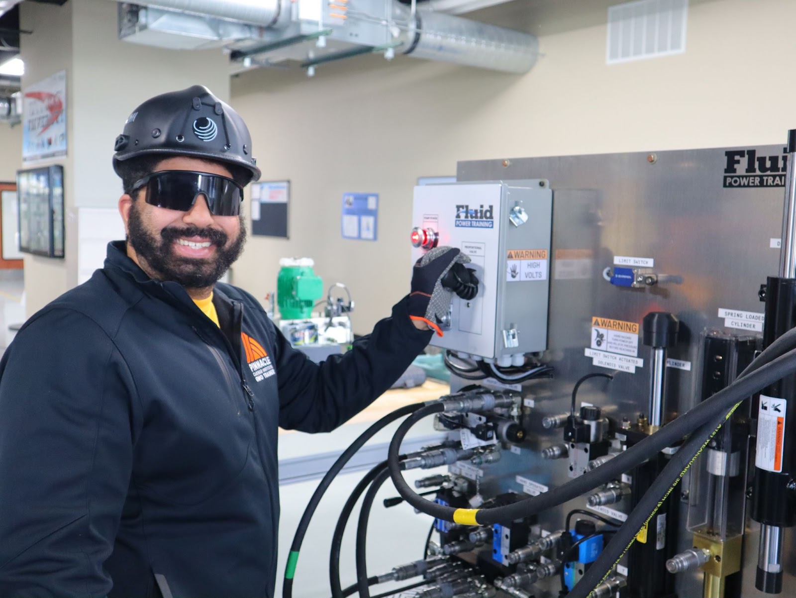 Lead GWO Trainer at Pinnacle Career Institute demonstrating a fluid power training system used in wind turbine technician training. PCI’s hybrid trade school program prepares students for careers in renewable energy with hands-on instruction from industry experts.