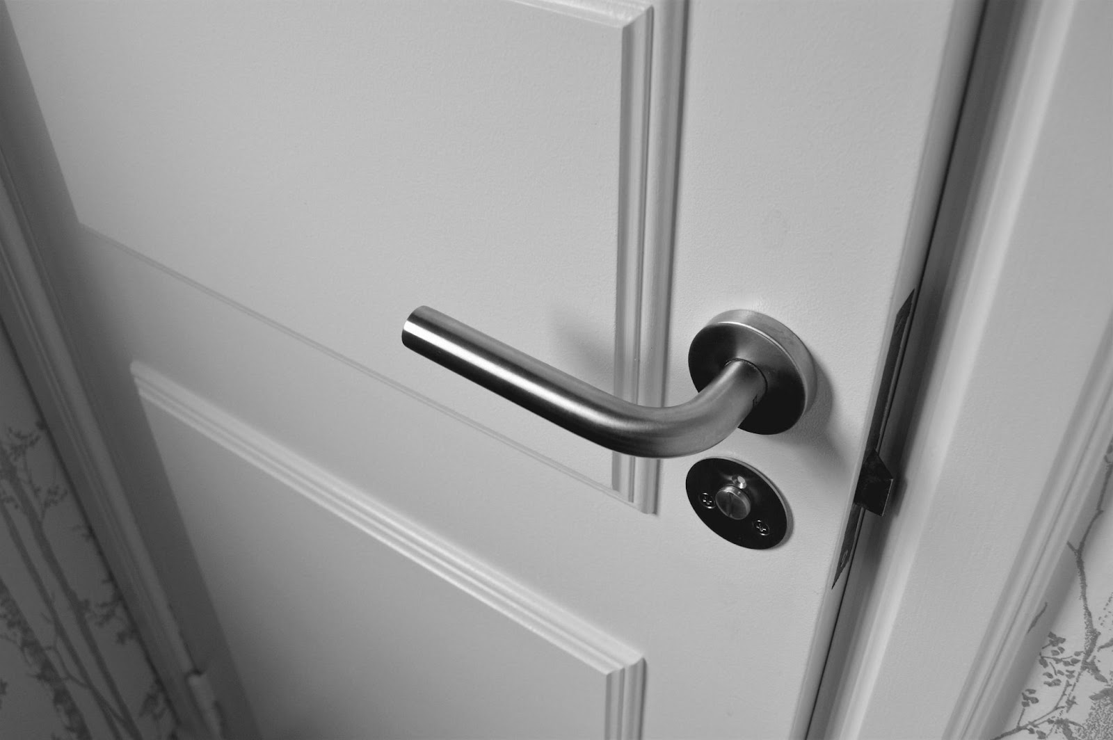 A white door with a silver knob