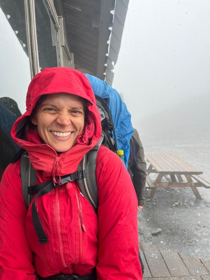 A person wearing a red jacket and backpackAI-generated content may be incorrect.