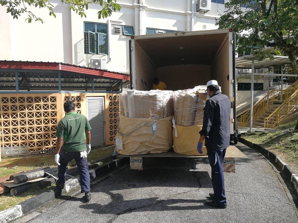 Men loading a truck with bags of goods

Description automatically generated with medium confidence