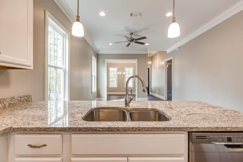 The kitchen peninsula is fitted with double sinks and a dishwasher.