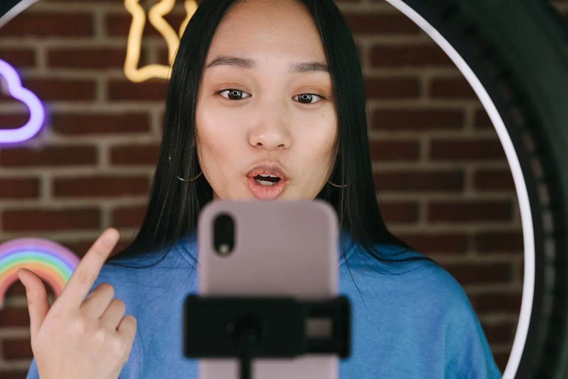 Close-up of TikTok app open on a smartphone, capturing remix culture and content reuse