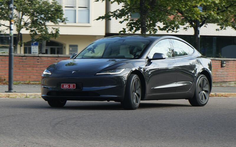 A black car on the road

Description automatically generated
